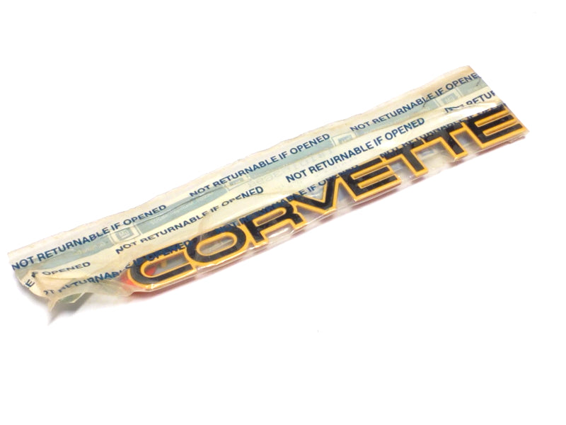 New OEM 1984-1990 CORVETTE Yellow W/Black Letters Bumper Emblem, Part # 10153698